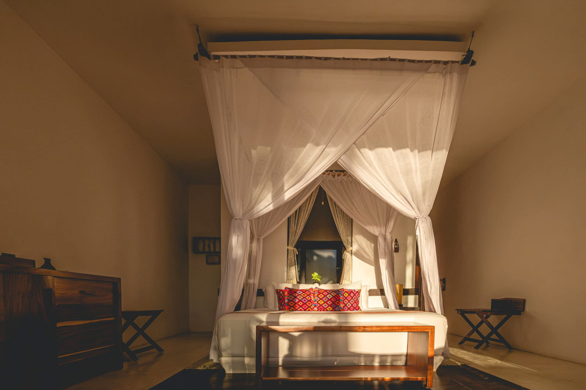 Bedding in a Rooftop room at The Beach Tulum Hotel ina warm light at dawn